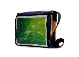 Upcycling shoulder bag with transparent slip-in compartment